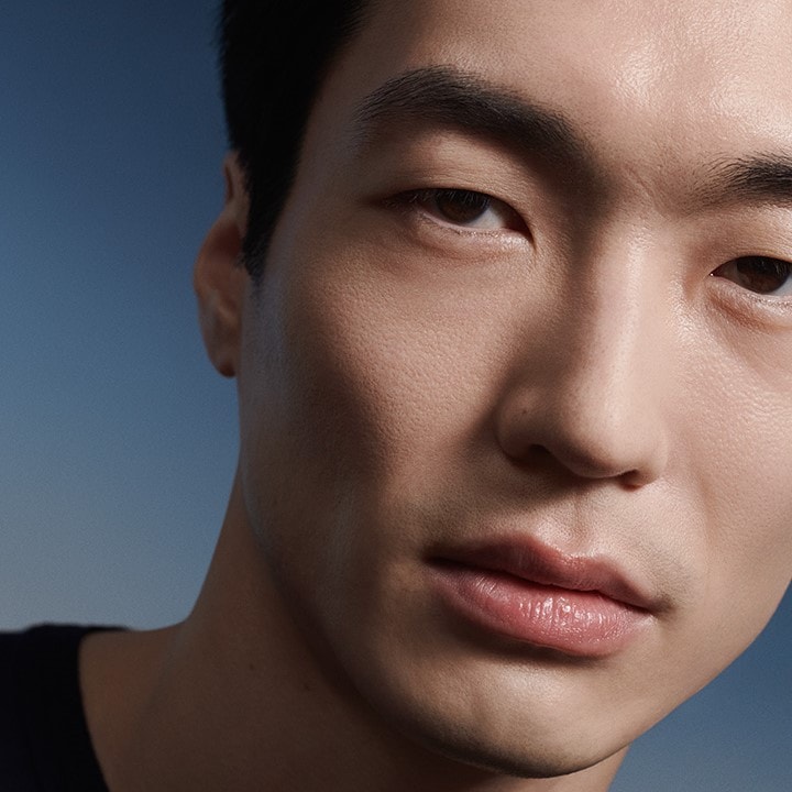 Close up of Male face looking straight out with moody lighting.