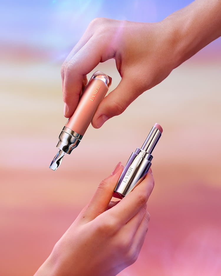 Shop lip treatments with lip volumizer and lip treatment two hands holding against gradient pink background 